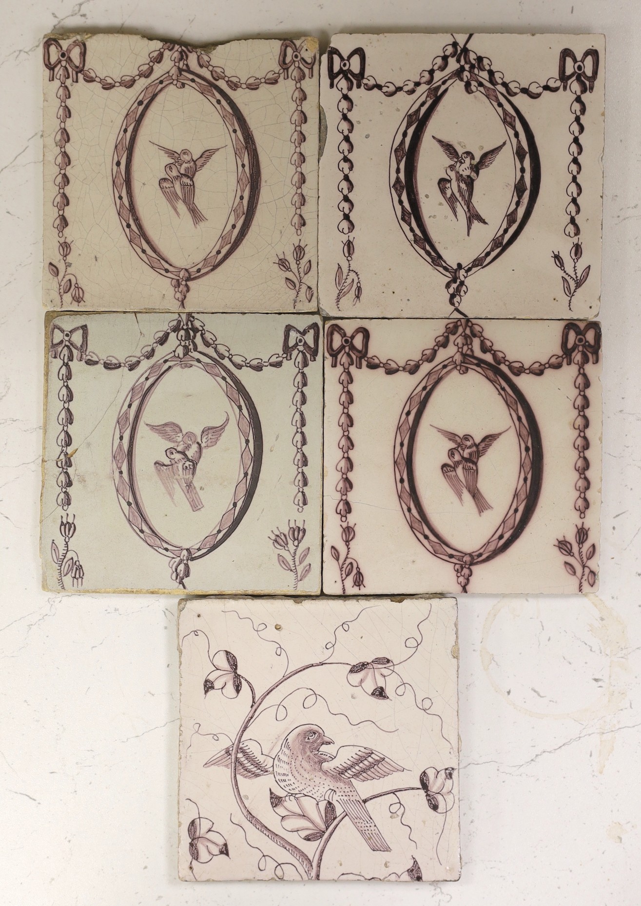 Four Delft manganese neo-classical ‘love bird’ tiles and a similar ‘dove’ tile, late 18th century (5)